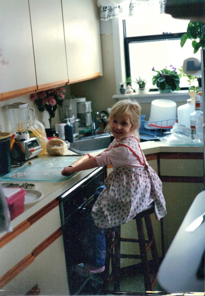Rae Gabler-Kirbos with rolling pin as a child